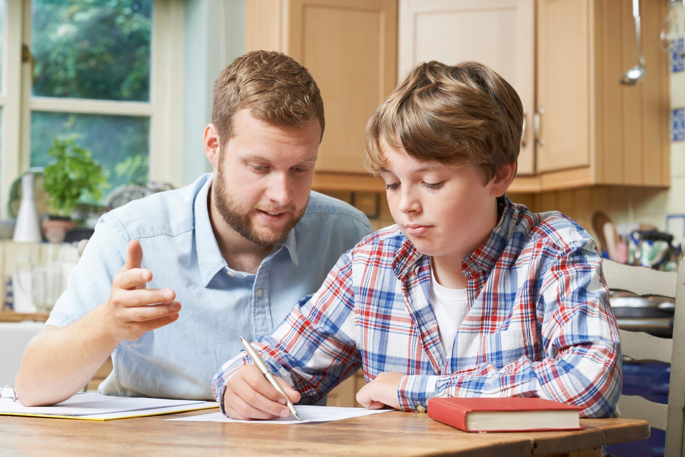 A carer helping a young person learn at home