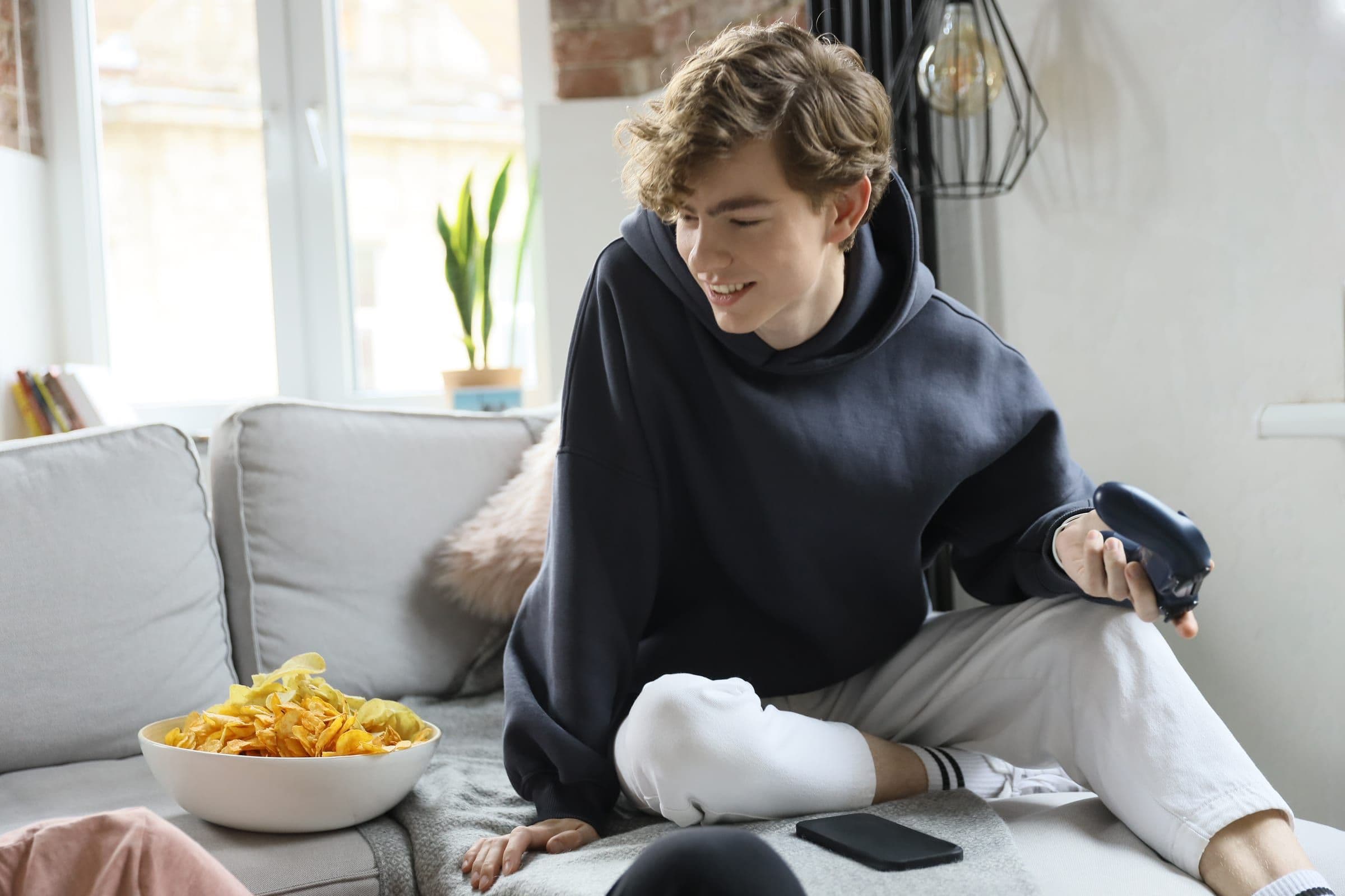 A young person relaxing at home on the sofa